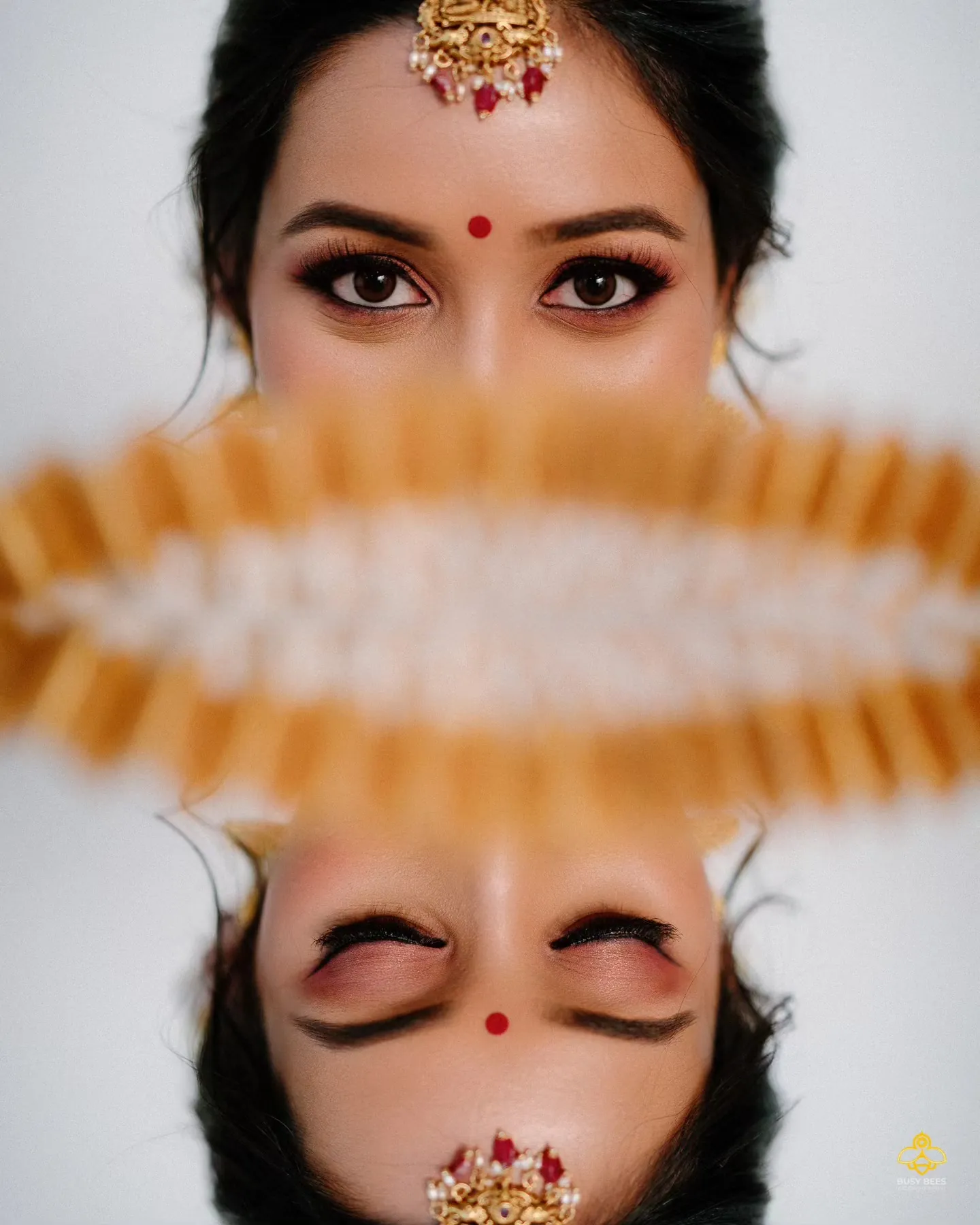 Graphic double portrait of the bride's eyes above a mirrored reflection