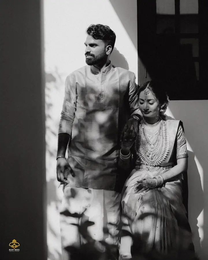 Black and white portrait of the couple in hard doorway light